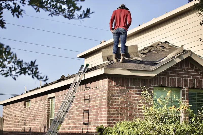 Professional roofer working on a residential roof in Arts District